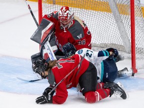 PWHL Ottawa's Jincy Roese (71) and PWHL New York forward Jade Downie-Landry (27) crash into goalie Emerance Maschmeyer during the first period in Ottawa on Wednesday, Feb. 28, 2024.
