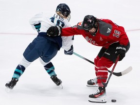 PWHL Ottawa forward Brianne Jenner and PWHL New York forward Paetyn Levis battle for the puck during the second period in Ottawa on Wednesday, Feb. 28, 2024.
