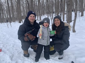 Brigitte Adm, her partner Jeff Donnelly and her three-year-old son William were making the most of a chilly morning in the forest, Saturday, tapping maple trees while protected by pocket-warmers and battery powered socks.