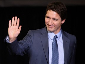 Prime Minister Justin Trudeau waves as he leaves after testifying at the Public Order Emergency Commission in Ottawa on Nov. 25, 2022.
