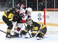 Ottawa 67's captain Luca Pinelli (20) tries unsuccessfully to jam the puck under the left leg of Brantford Bulldogs goaltender Matteo Drobak.