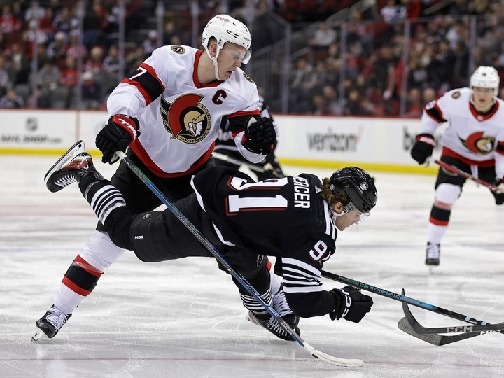  Senators captain Brady Tkachuk knocks Dawson Mercer of the Devils to the ice during the second period on Saturday night.