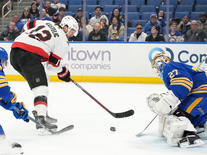  Devon Levi of the Buffalo Sabres makes the save against Mark Kastelic of the Ottawa Senators during the first period at KeyBank Center on March 27, 2024 in Buffalo.