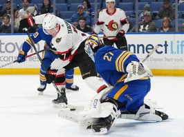 Brady Tkachuk of the Ottawa Senators scores a goal against Devon Levi of the Buffalo Sabres during the first period at KeyBank Center on March 27, 2024 in Buffalo.