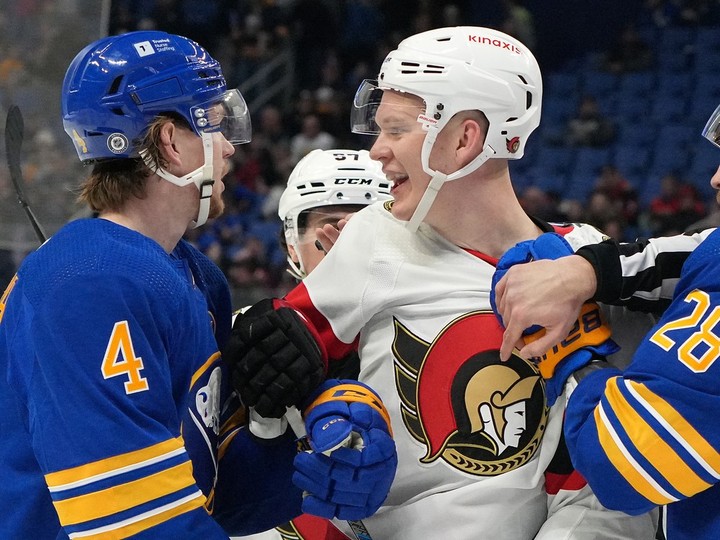  Ottawa Senators captain Brady Tkachuk gets tangled up with Bowen Byram and other Buffalo Sabres during a scrum in the second period at KeyBank Center on March 27, 2024 in Buffalo.