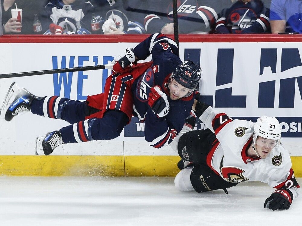Winnipeg's Josh Morrissey and Ottawa's Parker Kelly collide during the first period of Saturday's game.