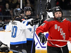 Toronto's Natalie Spooner (24) celebrates her goal with Blayre Turnbull (40) as Ottawa's Natalie Snodgrass (8) skates away during the first period in Ottawa on Saturday, March 2, 2024.