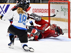 Ottawa's Emerance Maschmeyer (38) falls as she makes a save on Toronto's Jesse Compher (18) during the first period in Ottawa on Saturday, March 2, 2024.