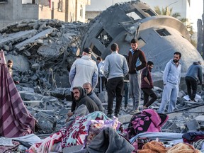 Palestinians stand amid the rubble of a mosque that was destroyed in Israeli strikes in Deir El-Balah in central Gaza on March 2, 2024.