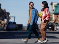 Two member of the Ottawa band Pony Girl stroll along the street.