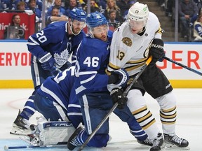 TORONTO, CANADA - Charlie Coyle #13 of the Boston Bruins is tied up by Ilya Lyubushkin #46 of the Toronto Maple Leafs in Game Three of the First Round of the 2024 Stanley Cup Playoffs at Scotiabank Arena on April 24, 2024 in Toronto, Ontario, Canada.