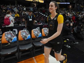 Iowa's Caitlin Clark smiles as she arrives for practice for the NCAA Women's Final Four championship basketball game Saturday, April 6, 2024, in Cleveland.