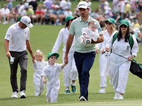 Nick Taylor of Canada walks to the second green with his family during the Par Three Contest prior to the 2024 Masters Tournament at Augusta National Golf Club on Wednesday.