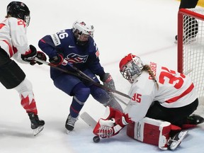 Canada goaltender Ann-Renee Desbiens (35) makes a save against United States' Kendall Coyne Schofield (26) during second period gold medal hockey action at the IIHF world women's hockey championship in Utica, N.Y.,, on April 14, 2024.
