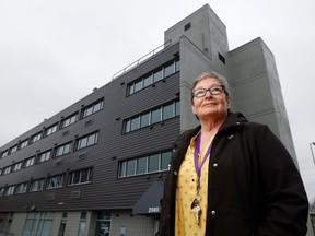 Martine Dore stands in front of the Carling Avenue building where Cornerstone for Women's Shelter will be moving to starting at the end of April.