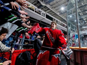 PWHL Ottawa goalie Sandra Abstreiter high fives fans following warmup and ahead of a game against PWHL New York in Ottawa on Feb. 28, 2024.