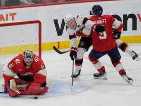 Florida Panthers goaltender Anthony Stolarz stops a shot on goal by Ottawa Senators captain Brady Tkachuk as centre Sam Bennett defends during the second period on Tuesday night in Sunrise, Fla.