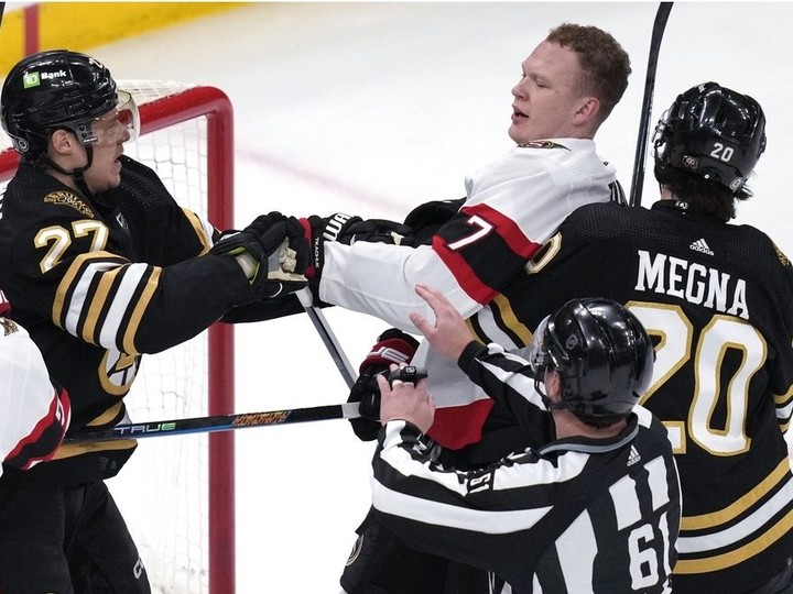  Ottawa Senators captain Brady Tkachuk tangles with Boston Bruins defenceman Hampus Lindholm during the first period on Tuesday night.
