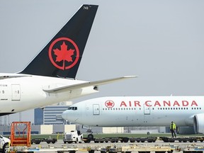 Air Canada planes sit on the tarmac at Pearson International Airport in Toronto on Wednesday, April 28, 2021.