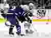 James van Riemsdyk of the Boston Bruins passes around Simon Benoit of the Toronto Maple Leafs