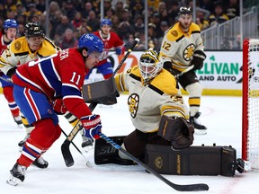 Brendan Gallagher of the Montreal Canadiens takes a shot on goal to score against Linus Ullmark of the Boston Bruins.