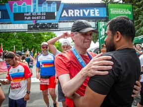 Ottawa Mayor Mark Sutcliffe was greeted at the finish line by Dhanushka Wickramasinghe,
