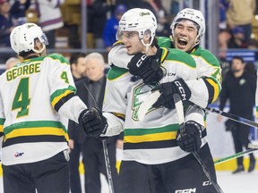 William Nicholl leaps on to the back of Sam Dickinson as the London Knights celebrate their series-clinching victory over the the Kitchener Rangers.