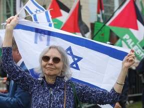Pro-Palestinian demonstrators and pro-Israeli supporters were both on the front lawn of Ottawa City Hall after the city raised an Israeli flag on Tuesday, May 14, 2024.