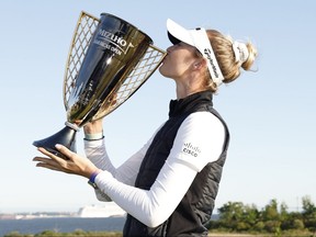 Nelly Korda of the United States poses with the winner’s trophy after winning the Mizuho Americas Open at Liberty National Golf Club on Sunday, May 19, 2024, in Jersey City, N.J.