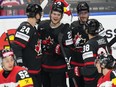 Canada's Kaiden Guhle, third from left, celebrates with teammates after scoring against Austria at the World Championships in Prague, Czechia, Tuesday, May 14, 2024.