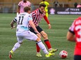 Pacific FC's Josh Heard, left, and Atletico Ottawa's Maxim Tissot battle for the ball during the first leg of their Canadian Championship quarterfinal match in Ottawa in this Wednesday, May 8, 2024 handout photo.