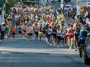 Participants leave the start line for the Ottawa Marathon on May 28, 2023.