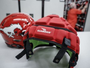 CFL players will have the option of wearing Guardian caps during games this season but mouthguards will be mandatory. A Guardian cap and a non-covered helmet are displayed at a Calgary Stampeders practice in Calgary on Tuesday, June 6, 2023.THE CANADIAN PRESS/Jeff McIntosh