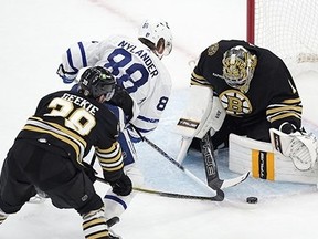 Boston Bruins' Jeremy Swayman blocks a shot by Toronto Maple Leafs' William Nylander as Morgan Geekie defends during the second period of Game 7, Saturday, May 4, 2024, in Boston.