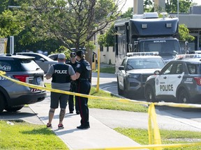 Toronto police officers investigate after three adults died in the lobby of an office space in Toronto, Monday, June 17, 2024.