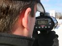 Fire photo of a policeman holding a radar gun.