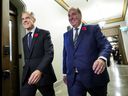 Prime Minister Mark Carney walks with MP Chris d'Entremont, who crossed the room from the Conservative caucus to join the Liberals, at a Liberal caucus meeting on Parliament Hill on Wednesday, November 5, 2025.