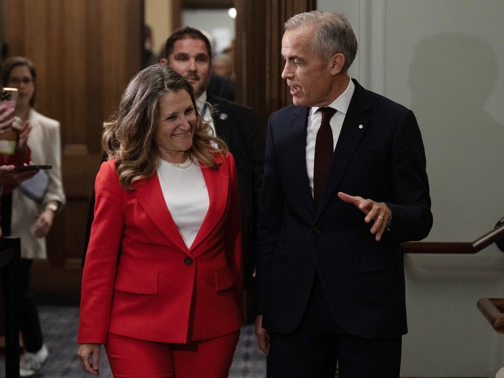 Mark Carney speaks with Chrystia Freeland as they leave a cabinet meeting on Parliament Hill in Ottawa on Tuesday, Sept. 16, 2025.