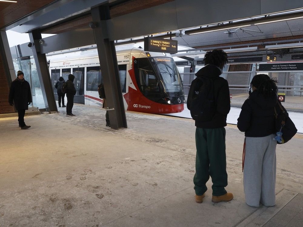 People wait for the LRT at Hurdman Station in Ottawa.