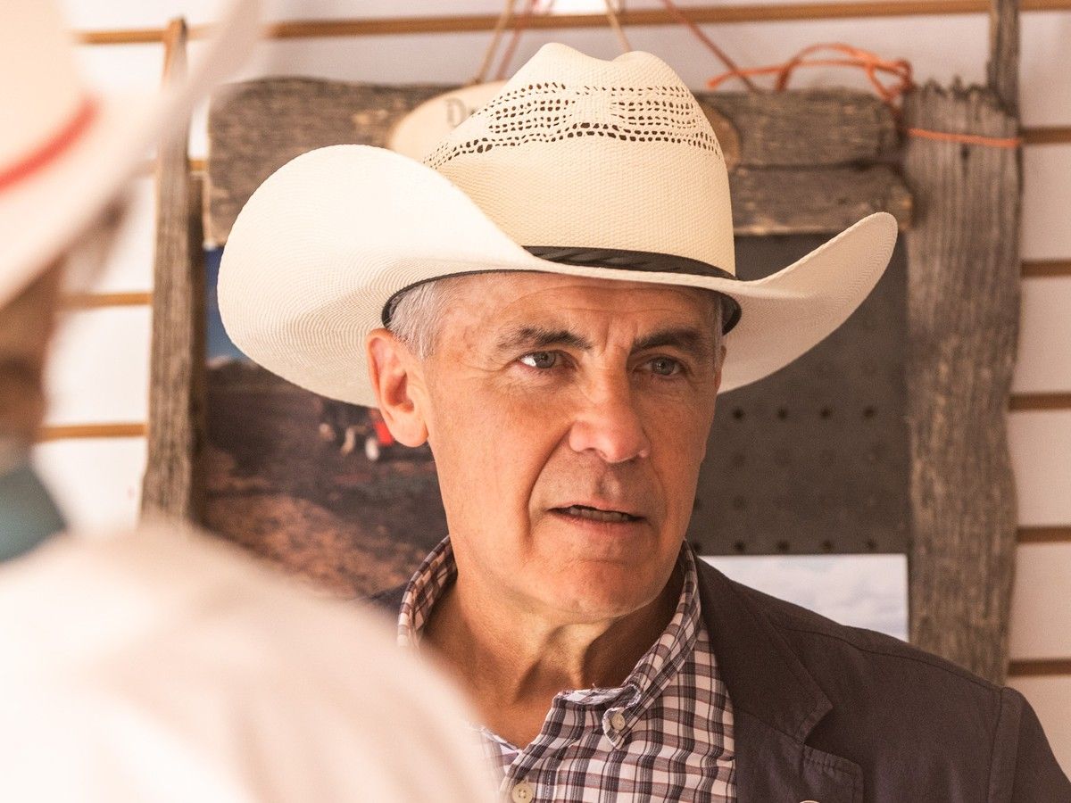 Prime Minister Mark Carney speaks with vendors and exhibitors during a visit to the Calgary Stampede on Sunday, July 12, 2026.