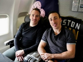 Boston Bruins winger Brad Marchand, right, and his younger brother Jeff enjoy the flight to an NHL game in Dallas. - Boston Bruins