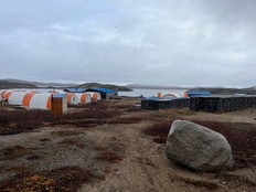 The Torngat Metals exploration base near the proposed Strange Lake rare earth mine in Quebec, with the Labrador side of the Strange Lake deposit visible on the horizon. On the right are stacks of core samples. Contributed/Torngat Metals
