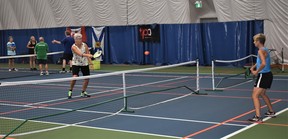 Rhonda Brassard and Deb Tully during a recent pickleball match at the Cougar Dome. The accessible game is steadily growing in popularity.