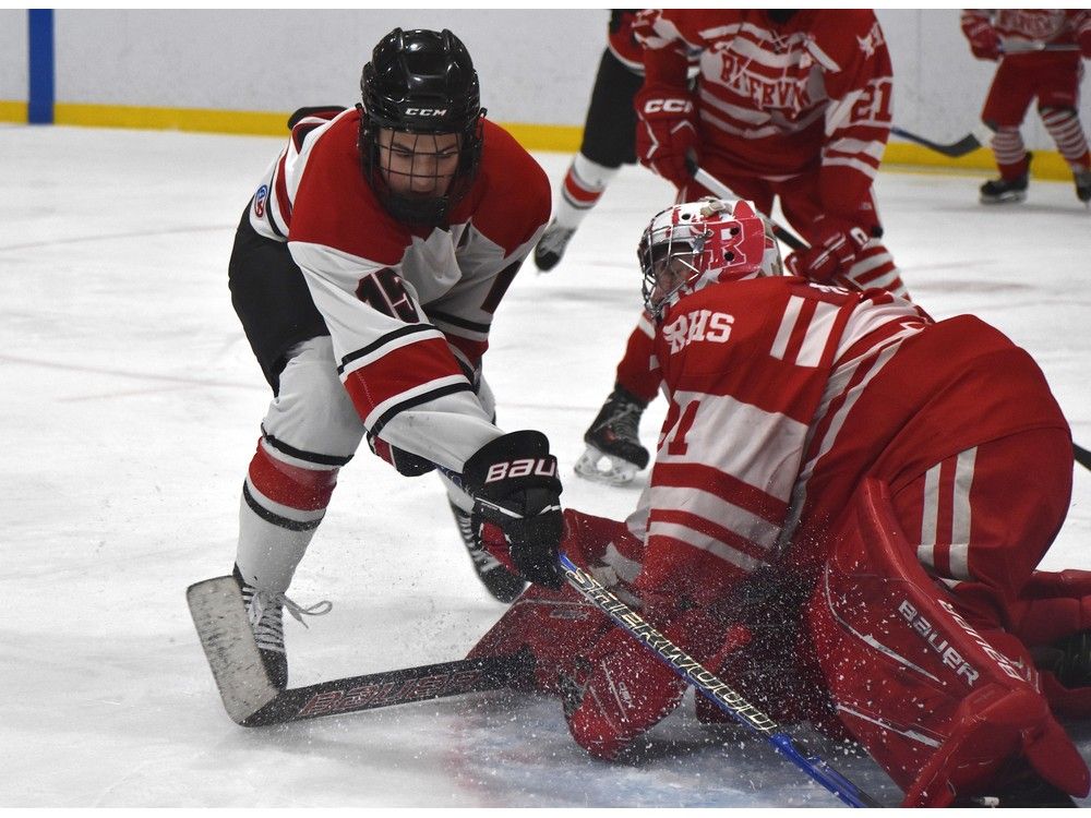 Kyle Nearing of the Glace Bay Panthers, left, attempts to jam the puck through the left pad of Riverview Ravens goaltender Kayden Mollons during School Sport Nova Scotia Highland Region Division 1 hockey championship action at Miners Forum in Glace Bay on Thursday. Riverview won the game 7-4. JEREMY FRASER/CAPE BRETON POST