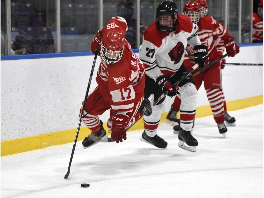 Matthew Burke of the Riverview Ravens, left, gets tripped up by Kolby Leforte of the Glace Bay Panthers during School Sport Nova Scotia Highland Region Division 1 hockey championship action at Miners Forum in Glace Bay on Thursday. Riverview won the game 7-4. JEREMY FRASER/CAPE BRETON POST