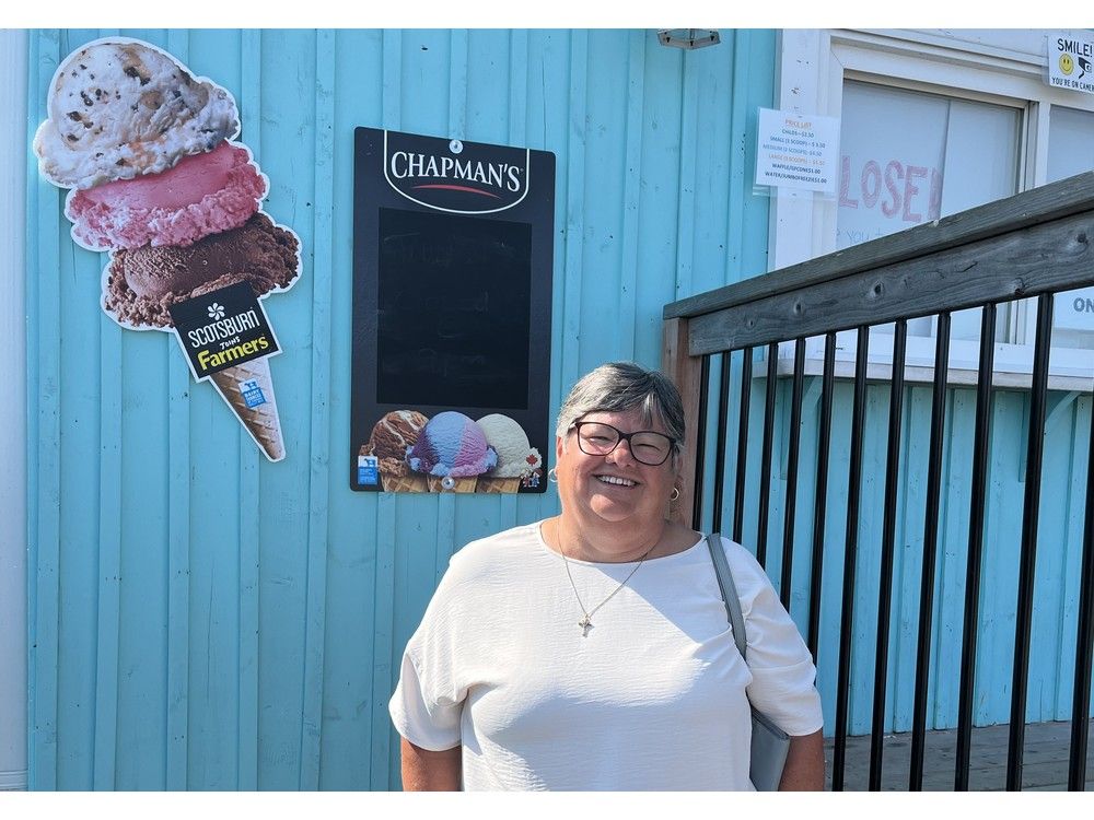  sarah white, co-chair of the st. bernard’s church ways and means committee in enfield, stands in front of the heavenly scoops ice cream shop next to the church on sunday.