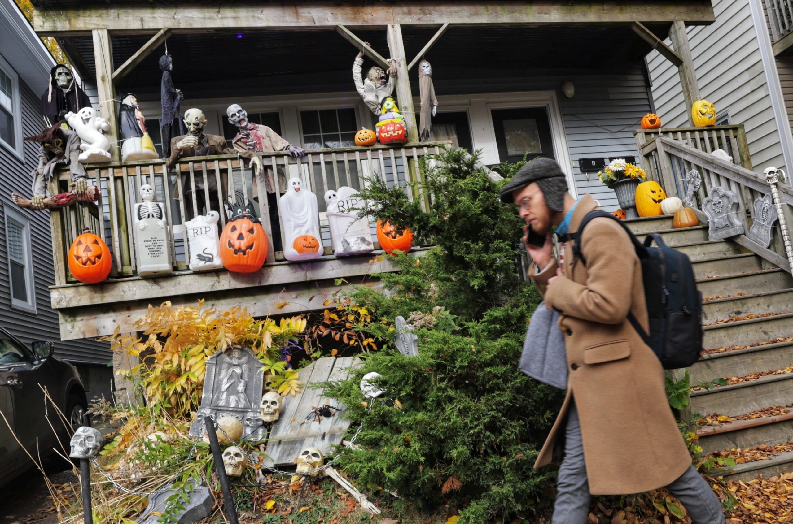 a person walks past a halloween display in front of a north street home in halifax on wednesday. a severe weather system is expected to hit nova scotia on halloween friday.