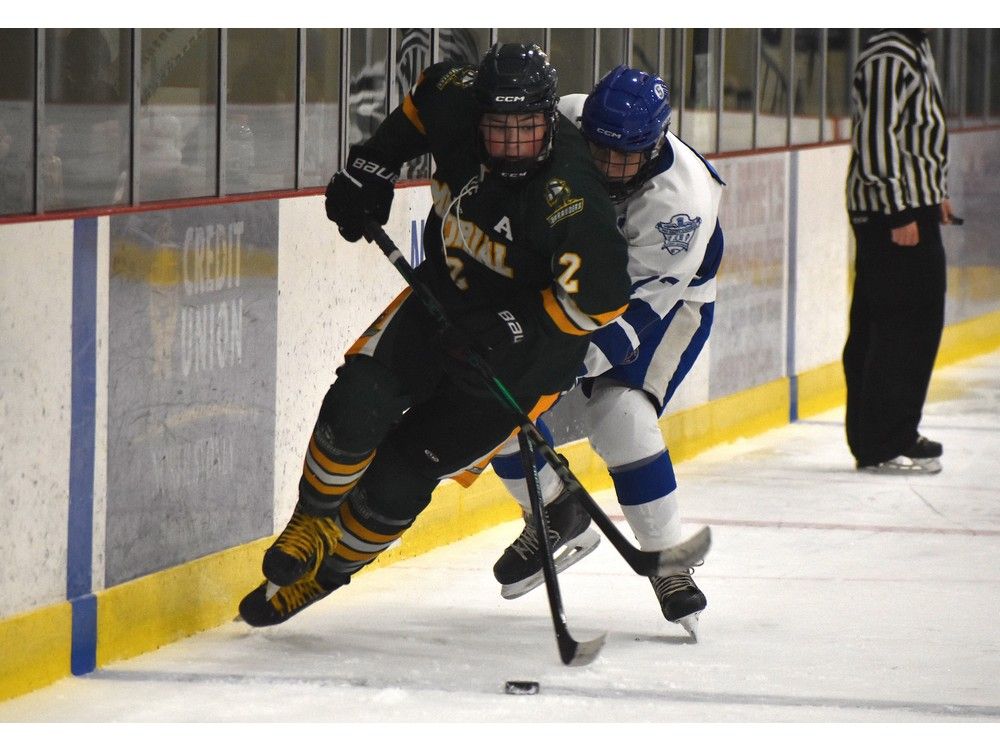 Jackson Gerrow of the Memorial Marauders, left, gets tripped up by Jaxon Gushue of the Sydney Academy Wildcats during Mae Kibyuk Memorial Green and Gold Hockey Tournament action at Emera Centre Northside in North Sydney on Thursday. JEREMY FRASER/CAPE BRETON POST