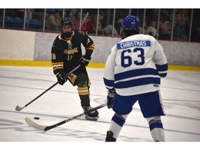 Tristan Walker of the Memorial Marauders looks for a pass option as he's watched by Jude Christmas of the Sydney Academy Wildcats during Mae Kibyuk Memorial Green and Gold Hockey Tournament action at Emera Centre Northside in North Sydney on Thursday. Memorial won the game 3-1. JEREMY FRASER/CAPE BRETON POST