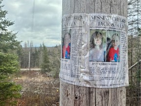 A missing persons poster of Lilly and Jack Sullivan on a telephone pole near their home along Highway 289.